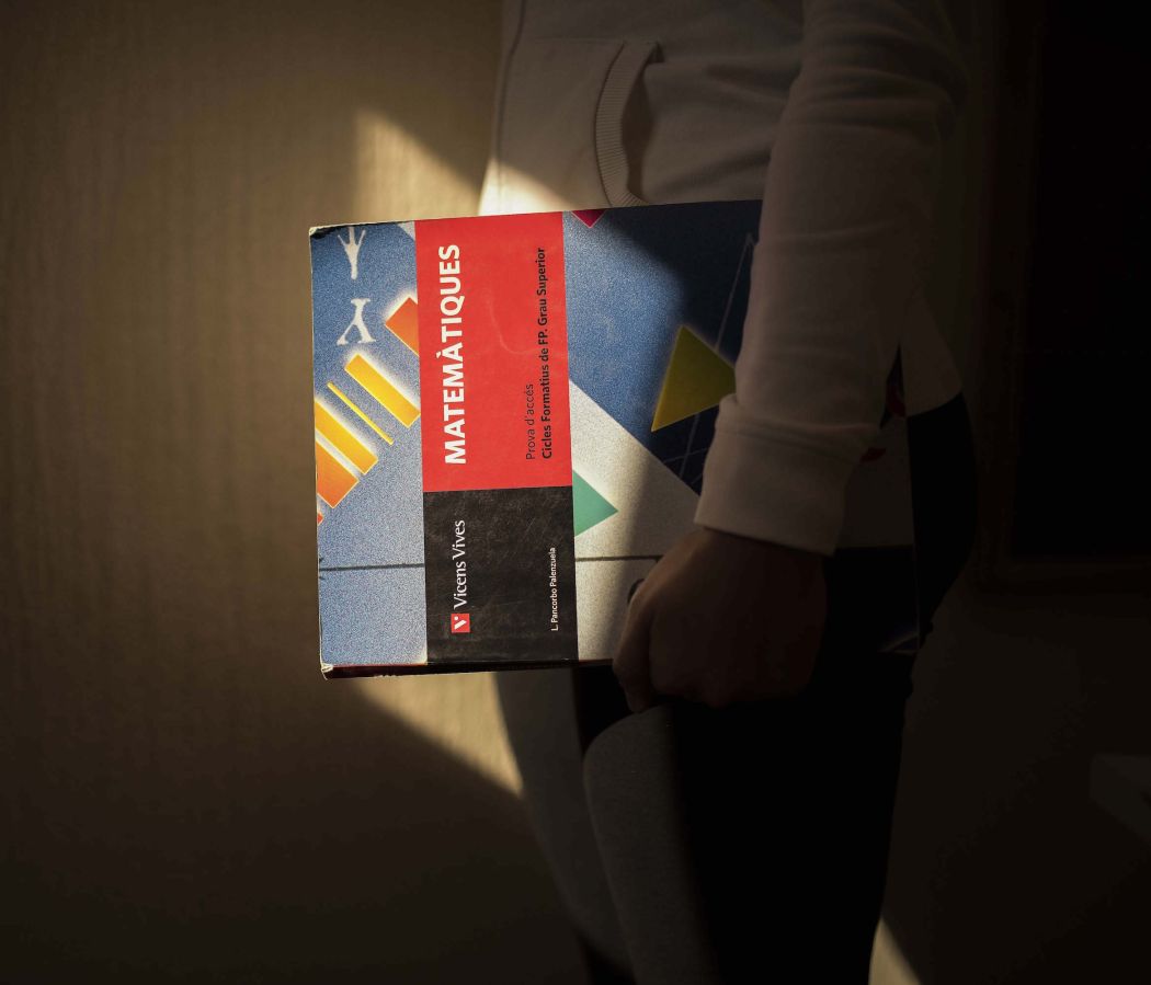 a shiny maths book over a dark background